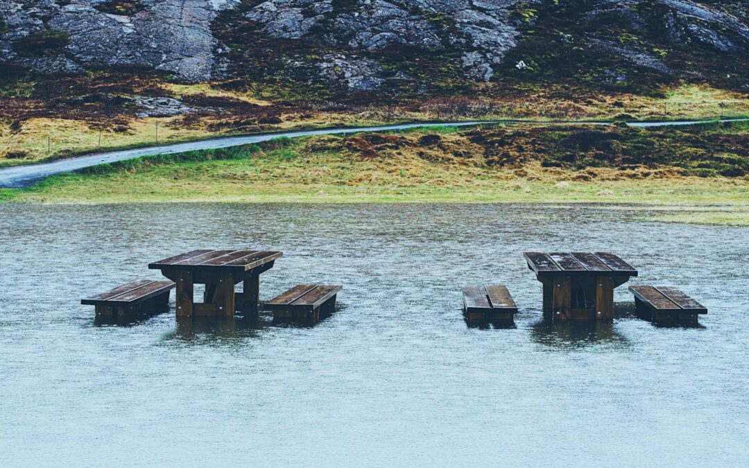 Photograph of picnic benches that have been surrounded by flood water